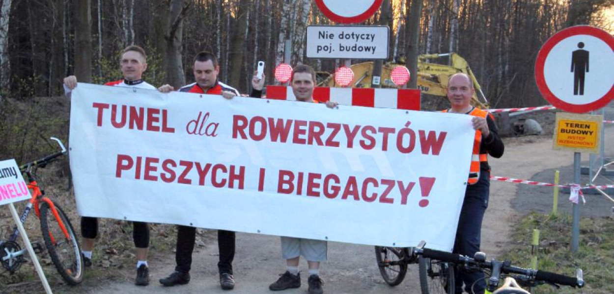 Pod ogrodzeniem budowy drogi rowerzyści rozwinęli duży baner