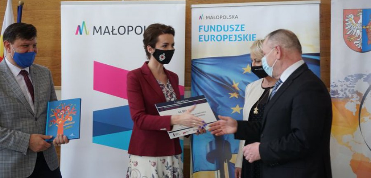Starosta Andrzej Uryga odbiera tzw. promesę na zakup laptopów od Marty Malec-Lech i Iwony Gibas z zarządu województwa oraz radnego wojewódzkiego Rafała Kosowskiego 